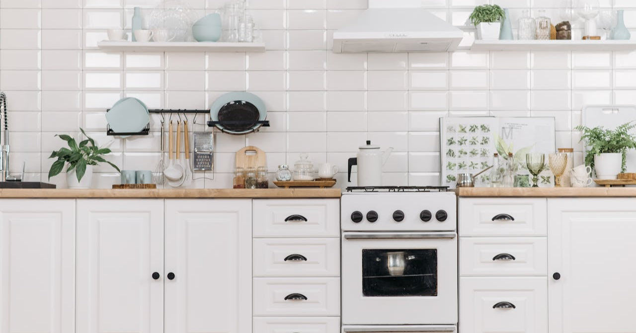 Modern kitchen with white appliances and wooden countertops